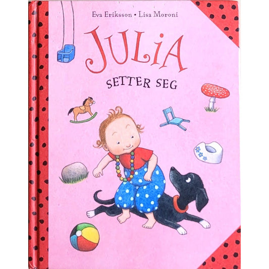 Julia setter seg, brukte bøker av Eva Eriksson og Lisa Moroni
